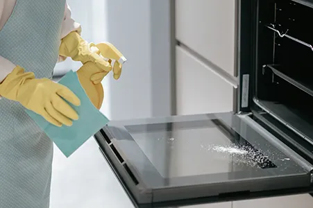Kitchen cleaning service in Cincinnati: polishing a refrigerator door