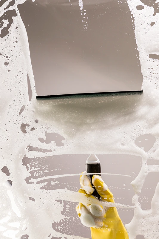 Post renovation cleaning: wiping drywall dust off a freshly painted wall