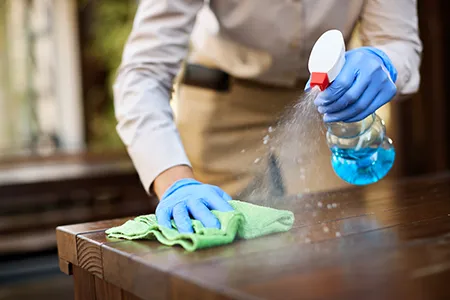 Types of cleaning services: a cleaner vacuuming a living room rug in a Cincinnati home