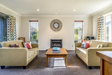 Cleaner vacuuming a living room during a recurring residential cleaning in Cincinnati